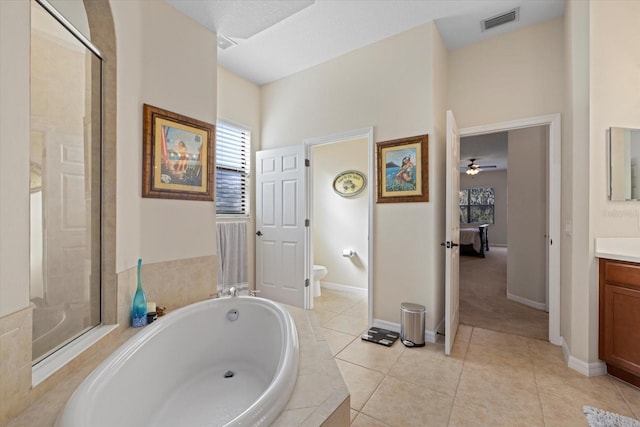 full bathroom featuring independent shower and bath, vanity, tile patterned floors, and toilet