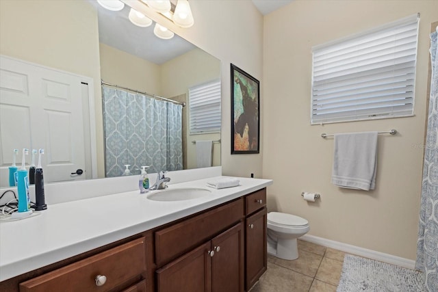 bathroom with vanity, tile patterned floors, and toilet