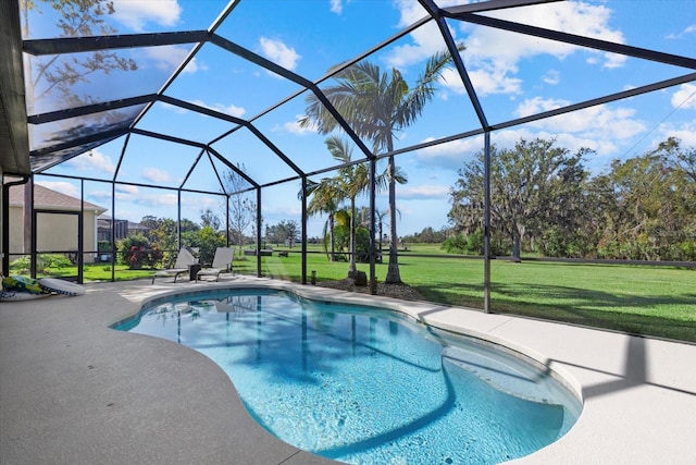 view of swimming pool with a patio, a lanai, and a lawn