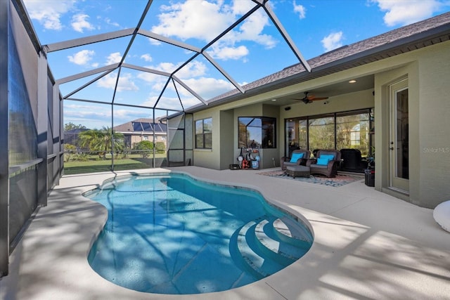 view of pool with ceiling fan, an outdoor living space, a lanai, and a patio area