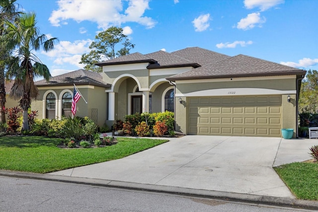 view of front of home featuring a garage and a front lawn