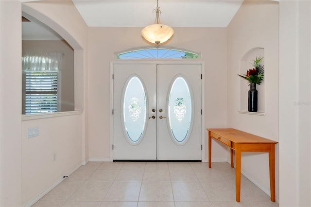 tiled entrance foyer with a wealth of natural light and french doors