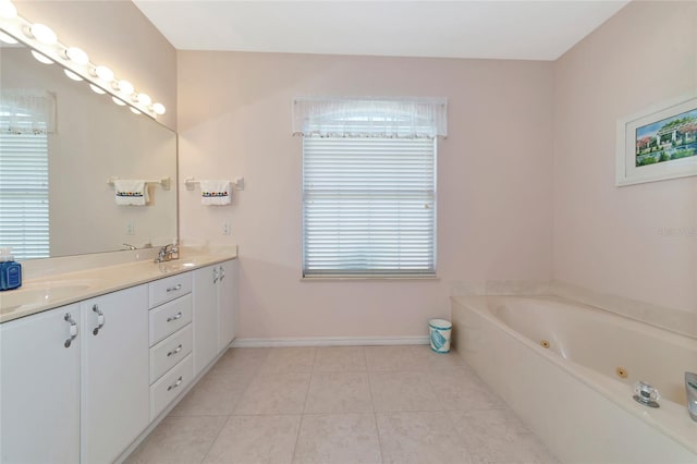 bathroom featuring tile patterned floors, vanity, a washtub, and a wealth of natural light