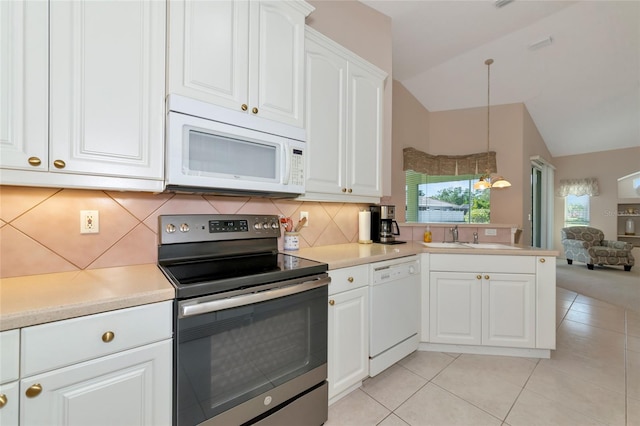 kitchen with white cabinetry, vaulted ceiling, white appliances, decorative backsplash, and light tile patterned floors