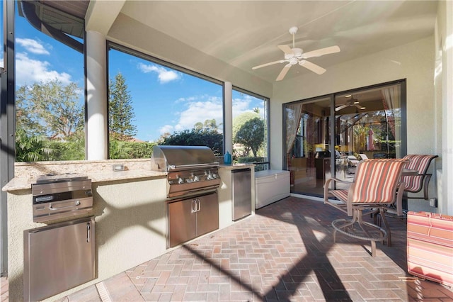 view of patio featuring an outdoor kitchen, ceiling fan, and a grill