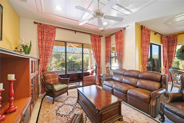 living room featuring plenty of natural light and ceiling fan