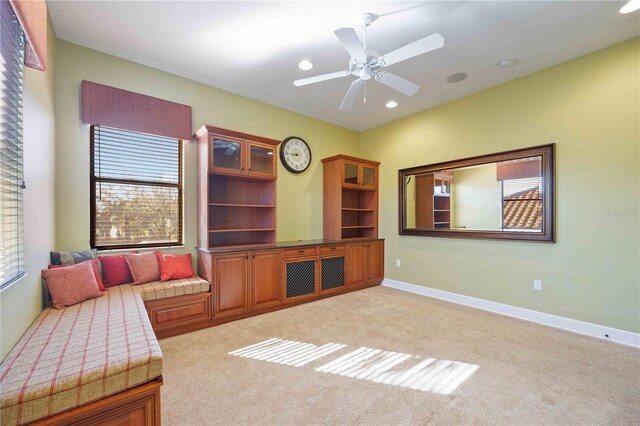 carpeted living room with ceiling fan