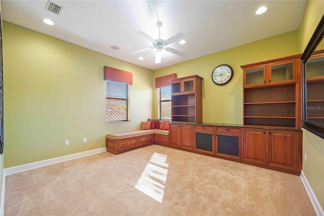 living room featuring light carpet and ceiling fan