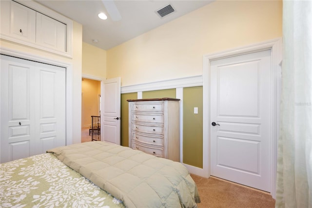 carpeted bedroom featuring a closet and ceiling fan