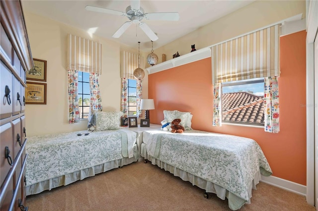 bedroom featuring ceiling fan, carpet floors, and multiple windows