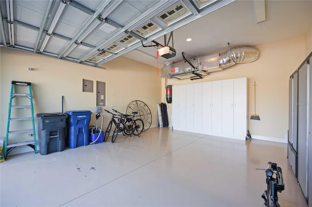 garage with electric panel and a garage door opener