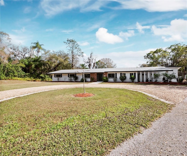 ranch-style house featuring a front lawn