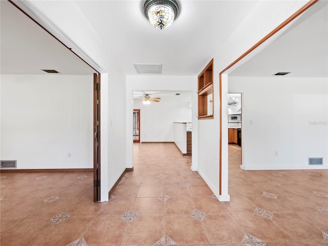 hall with light tile patterned floors