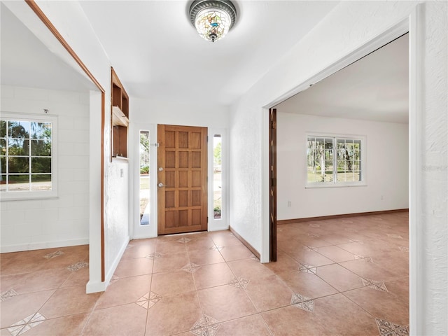 tiled foyer entrance featuring a healthy amount of sunlight