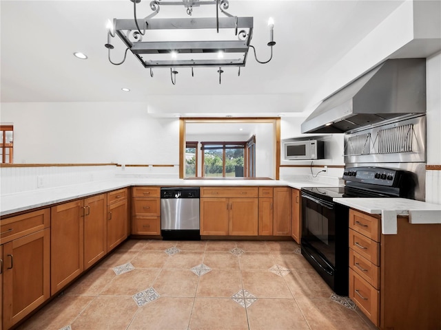 kitchen featuring dishwasher, electric range, wall chimney exhaust hood, light tile patterned floors, and kitchen peninsula