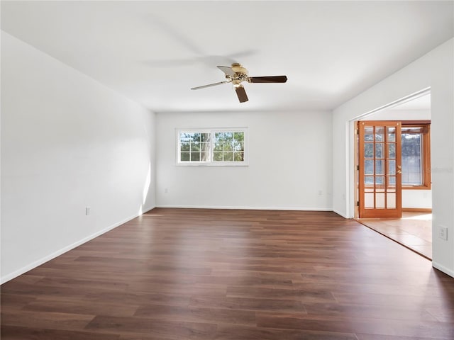 spare room with dark hardwood / wood-style floors, ceiling fan, and french doors