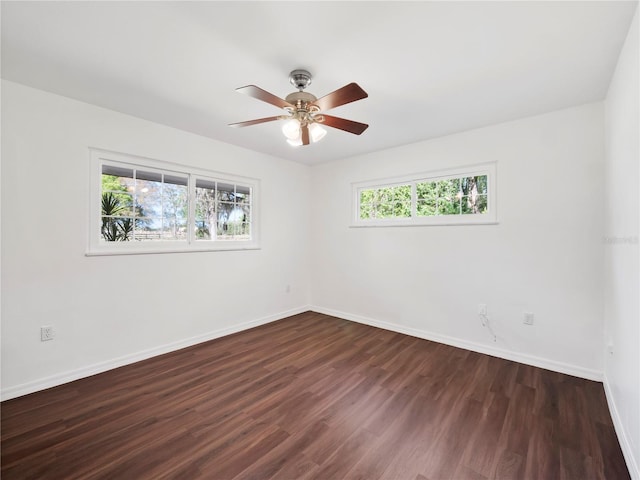 spare room featuring ceiling fan and dark hardwood / wood-style floors