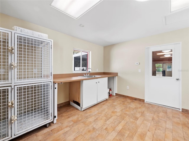 kitchen with light wood-type flooring and sink