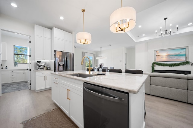 kitchen featuring a center island with sink, plenty of natural light, white cabinetry, and appliances with stainless steel finishes