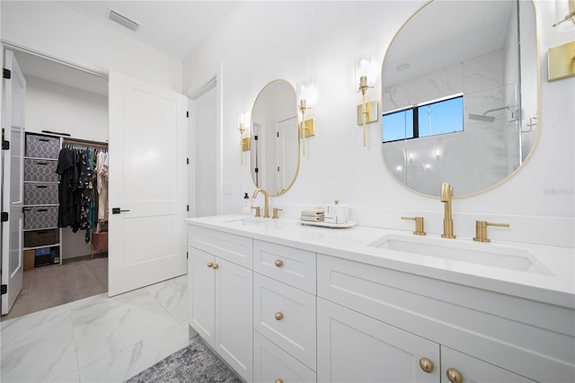 bathroom featuring vanity and tiled shower