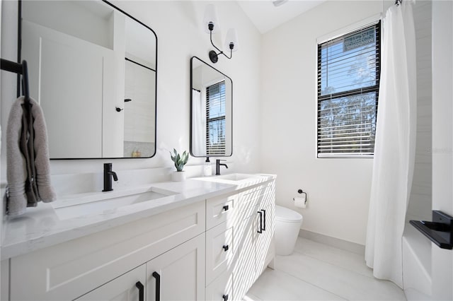 full bathroom featuring tile patterned flooring, vanity, toilet, and a wealth of natural light