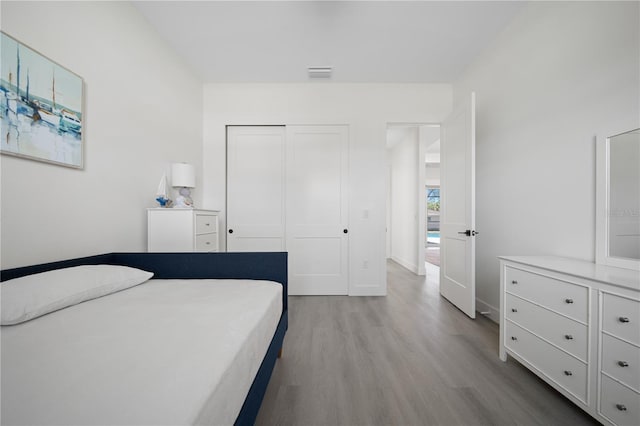 bedroom with a closet and light wood-type flooring