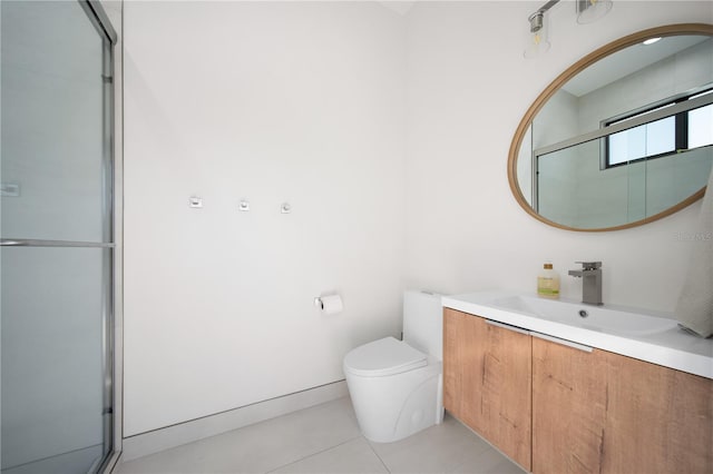 bathroom featuring tile patterned flooring, vanity, toilet, and a shower with shower door