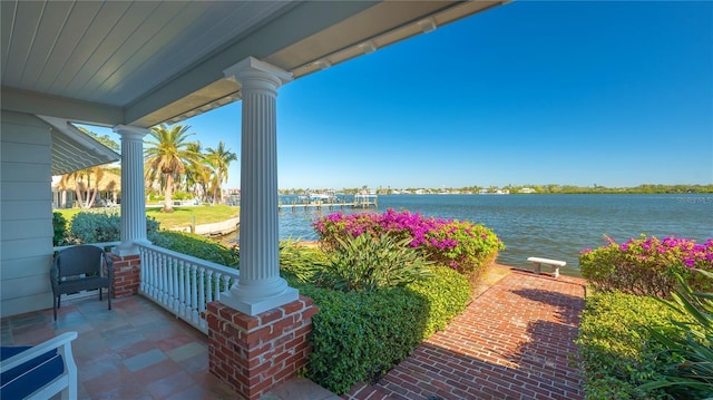 view of patio / terrace with a water view and covered porch