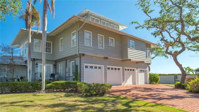 view of front of home with a garage and a front lawn