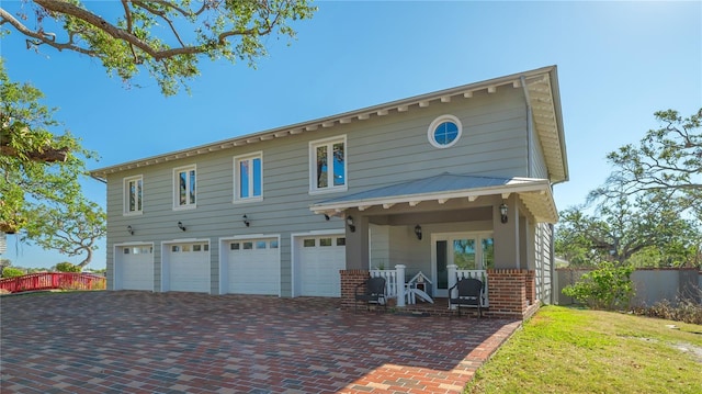 view of front of house featuring covered porch and a garage