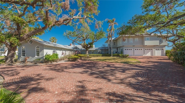 1249 S Basin Ln, Sarasota, FL 34242 - view of front of home with an attached garage and decorative driveway