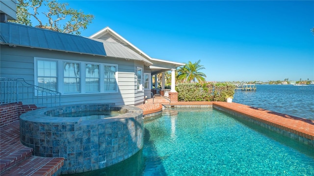 1249 S Basin Ln, Sarasota, FL 34242 - view of pool featuring a pool with connected hot tub and a water view