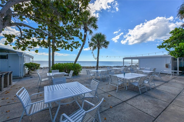 1249 S Basin Ln, Sarasota, FL 34242 - view of patio featuring outdoor dining area and a water view