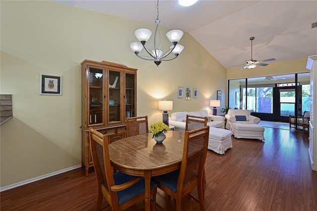 dining area with dark hardwood / wood-style floors, vaulted ceiling, ceiling fan with notable chandelier, and french doors