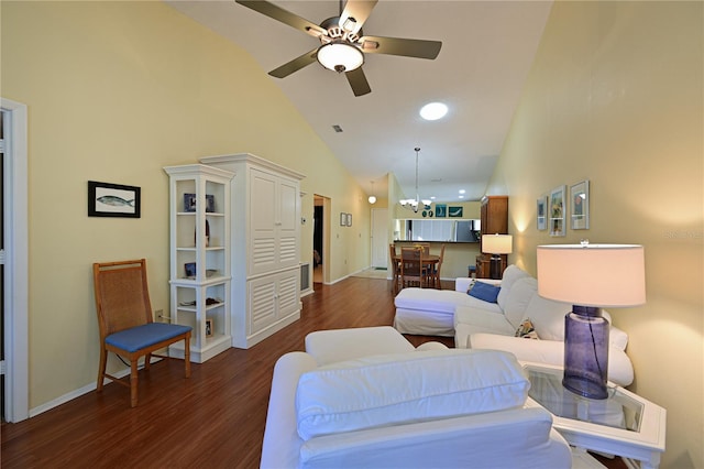 living room featuring ceiling fan with notable chandelier, dark hardwood / wood-style floors, and high vaulted ceiling