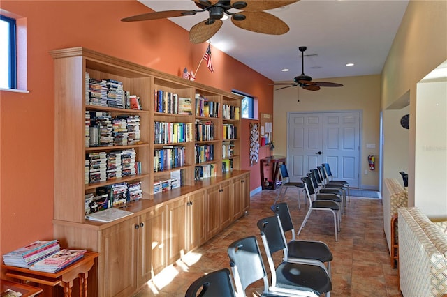 workout area with ceiling fan and light tile patterned floors