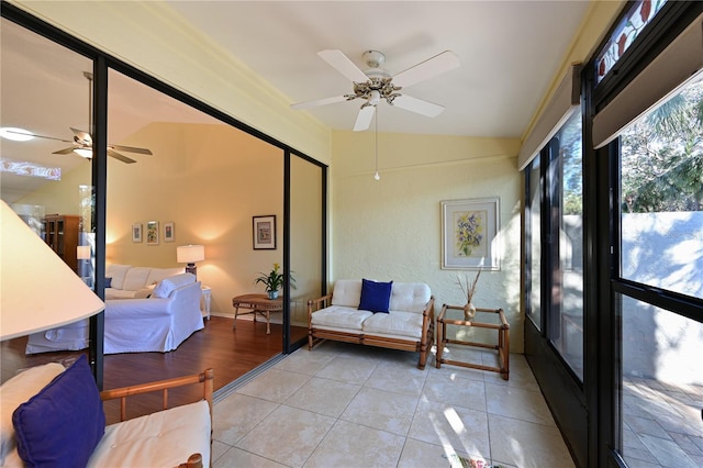 sunroom / solarium with ceiling fan and vaulted ceiling