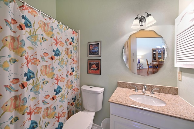 bathroom featuring vanity, toilet, and curtained shower