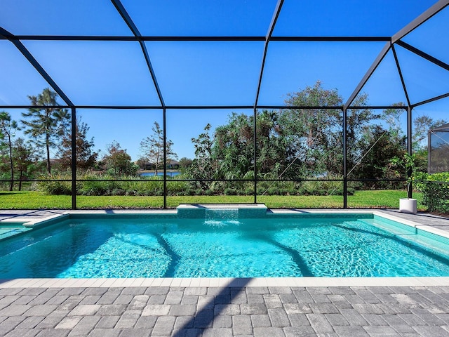 view of pool with pool water feature and glass enclosure