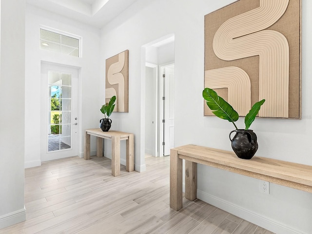 corridor with light hardwood / wood-style floors