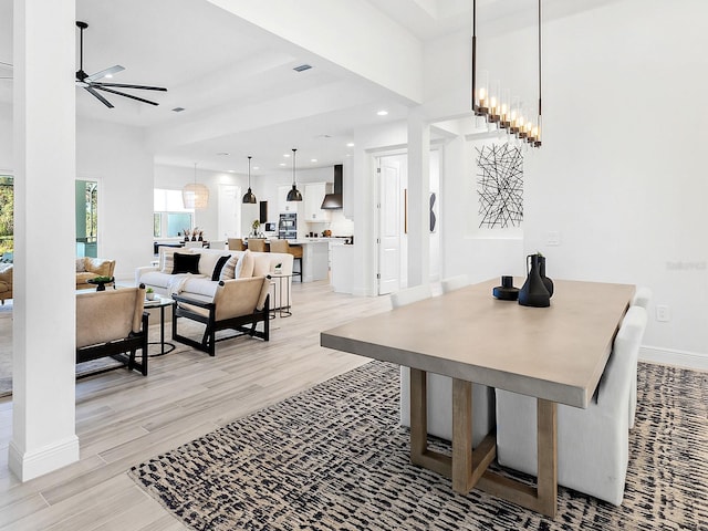 dining space featuring ceiling fan and light hardwood / wood-style flooring