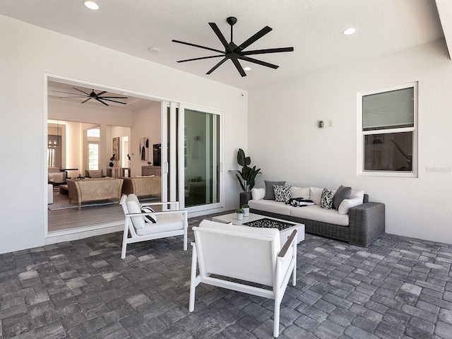 view of patio featuring an outdoor living space with a fire pit