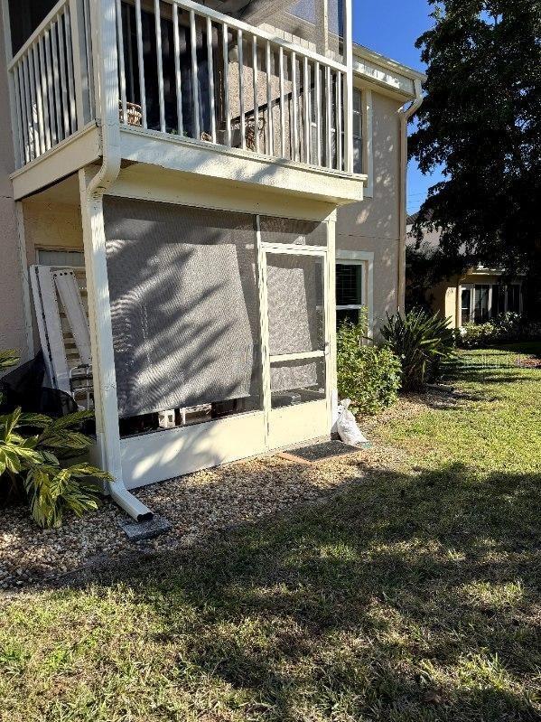 view of home's exterior featuring a yard and a balcony