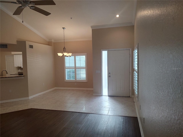 entrance foyer with crown molding, ceiling fan with notable chandelier, and hardwood / wood-style flooring