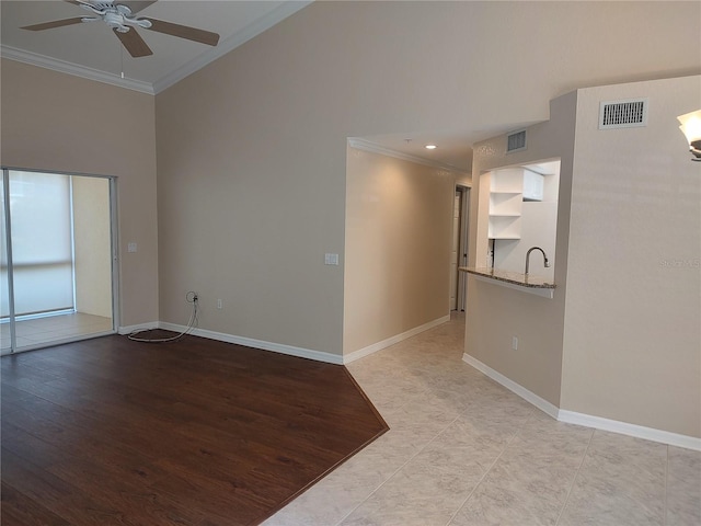 empty room featuring ceiling fan, crown molding, and light hardwood / wood-style flooring