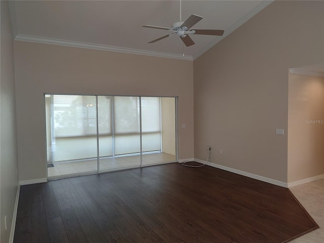 spare room with dark hardwood / wood-style floors, ceiling fan, crown molding, and a high ceiling