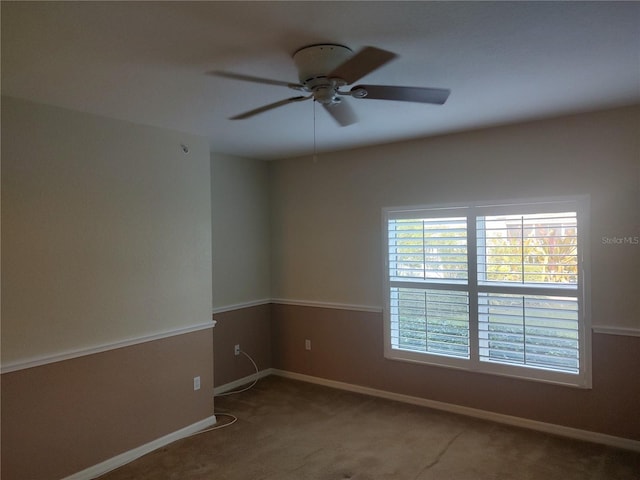 spare room featuring carpet and ceiling fan