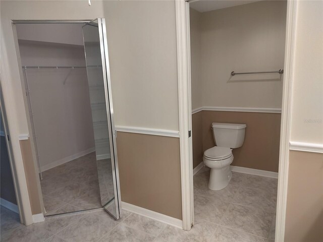 bathroom featuring tile patterned flooring and toilet