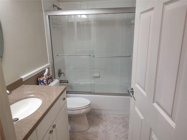 full bathroom with tile patterned flooring, vanity, enclosed tub / shower combo, and toilet