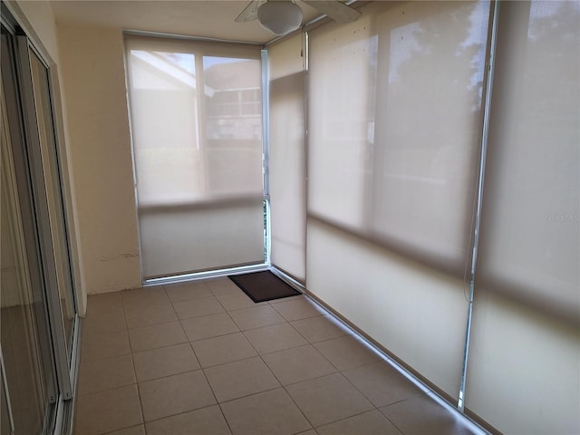 unfurnished sunroom with ceiling fan